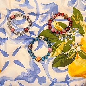 BRAND NEW! Without tags. Women's blue, red, and clear/silver bracelets.